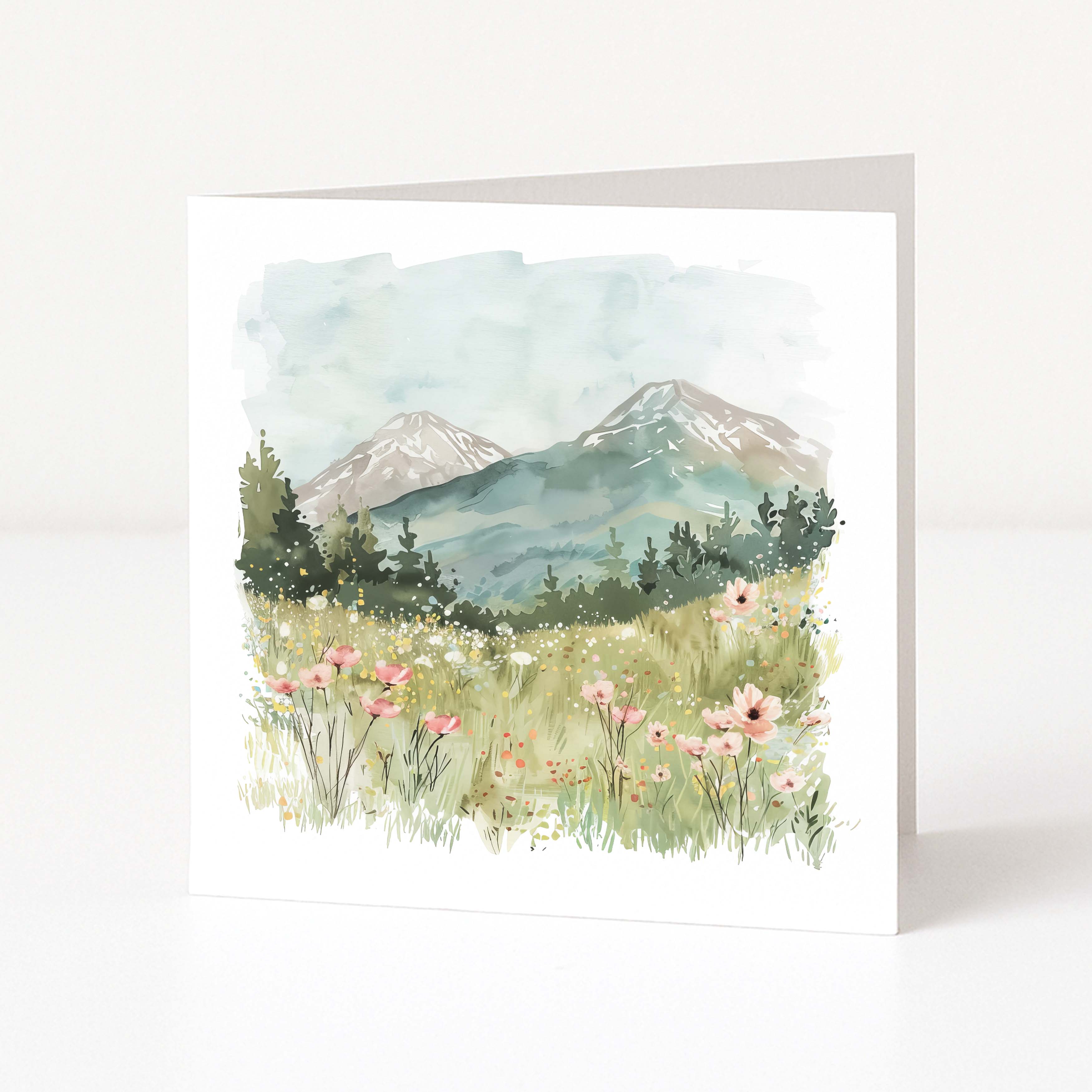 Greeting card with a mountain landscape and flowers on a white background