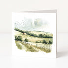 Greeting card with a scenic landscape illustration of a house on a hill.