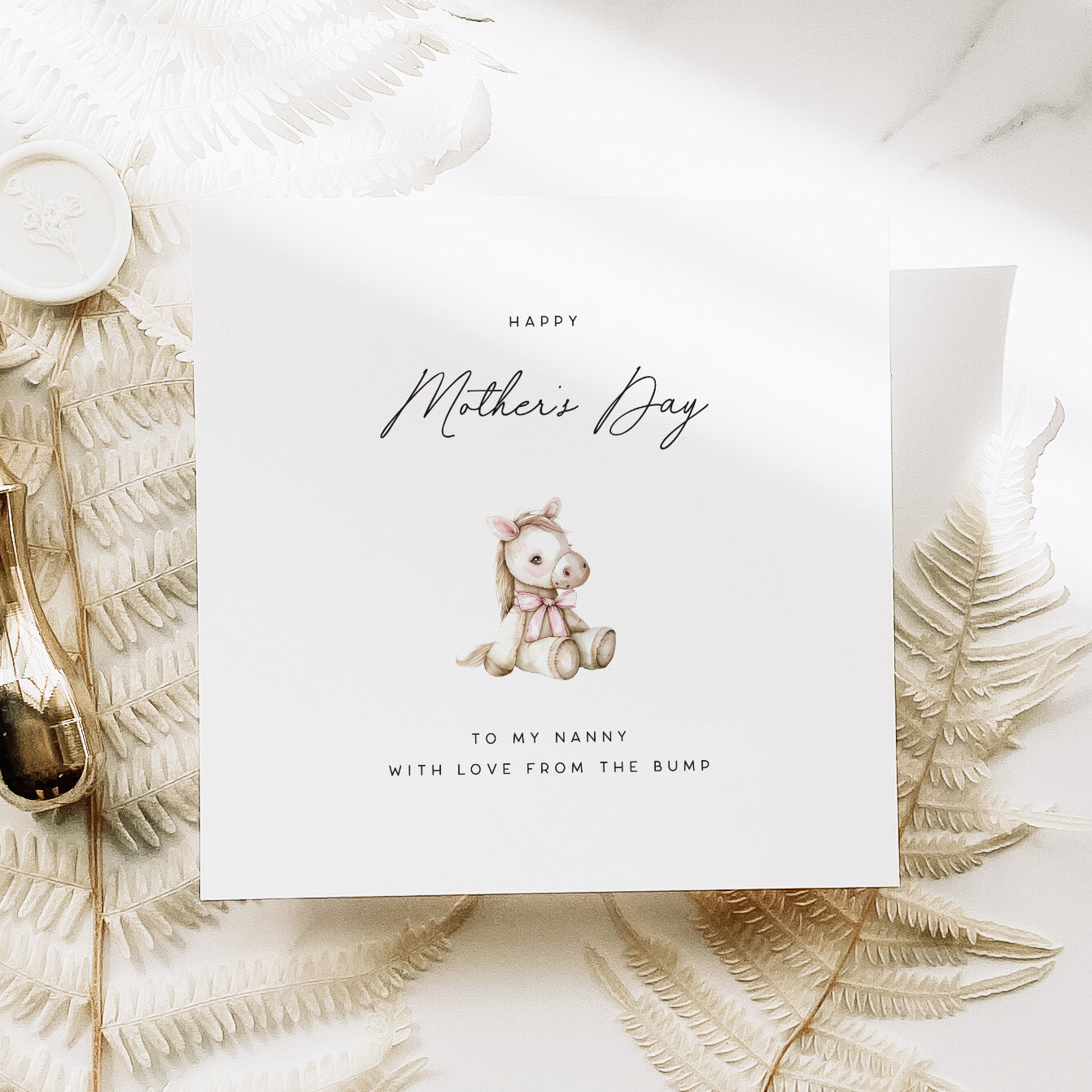 Greeting card with a baby pony illustration and 'Happy Mother's Day' text on a decorative background.