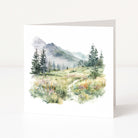 Greeting card with a mountain landscape featuring trees and flowers on a white background