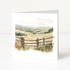 Greeting card with a scenic landscape featuring a wooden fence on a white background
