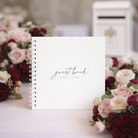 white guest book with white binder with burgundy and blush flowers