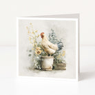 Greeting card with a rooster on a pot surrounded by flowers and plants.
