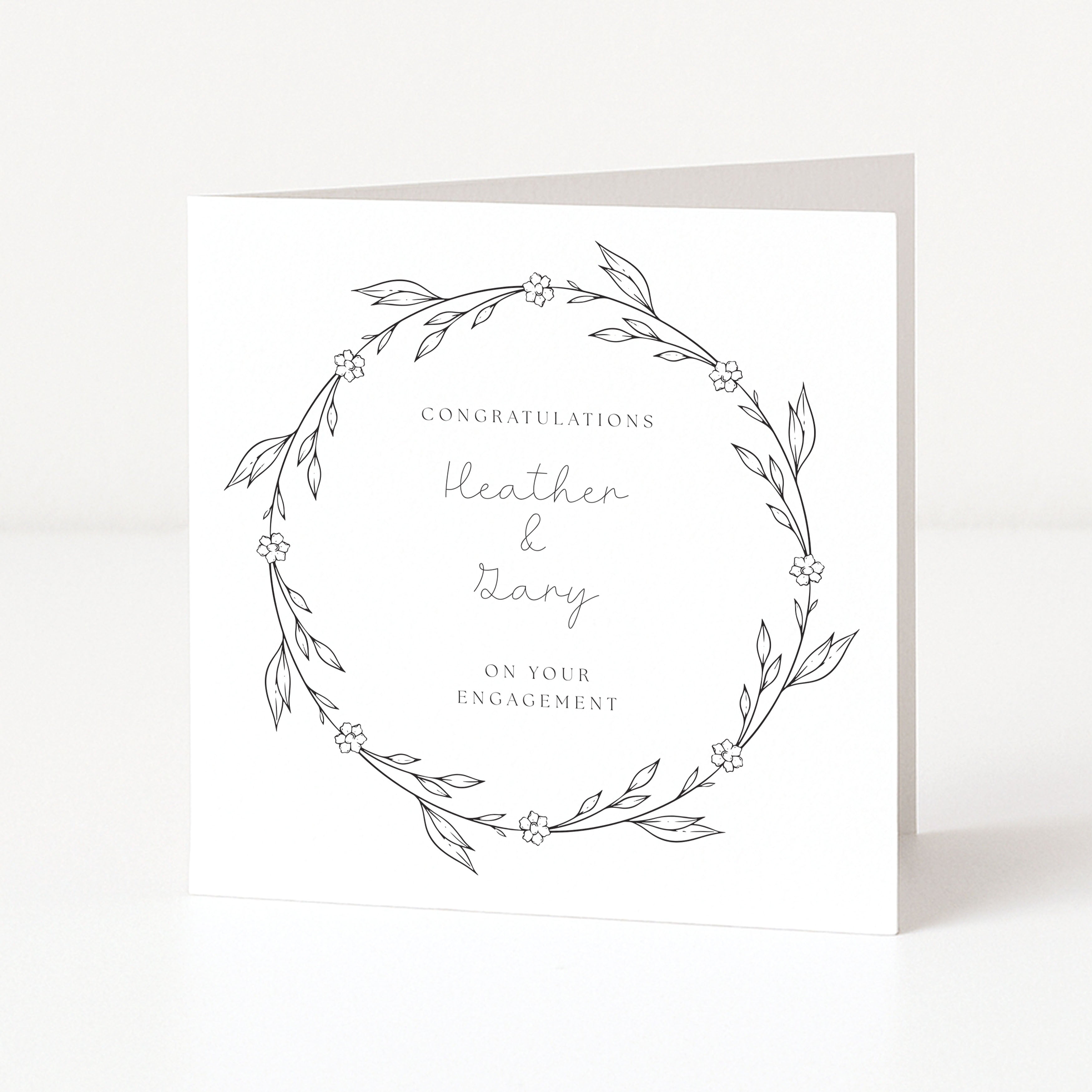 Greeting card with floral wreath design and text on a white background