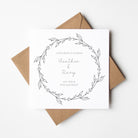 engagement card withblack wreath and custom text inside on a white bacgkground