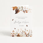 Wedding card with floral design and text on a white background