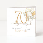 Personalised 70th birthday card for a friend with a large gold 70, neutral balloons and the name Dorothy.