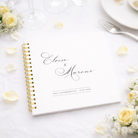white wedding guest book on white table cloth with yellow flowers