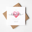 Greeting card with pink heart and text on a white background