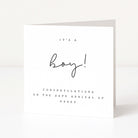 White card with black text celebrating the safe arrival of a boy