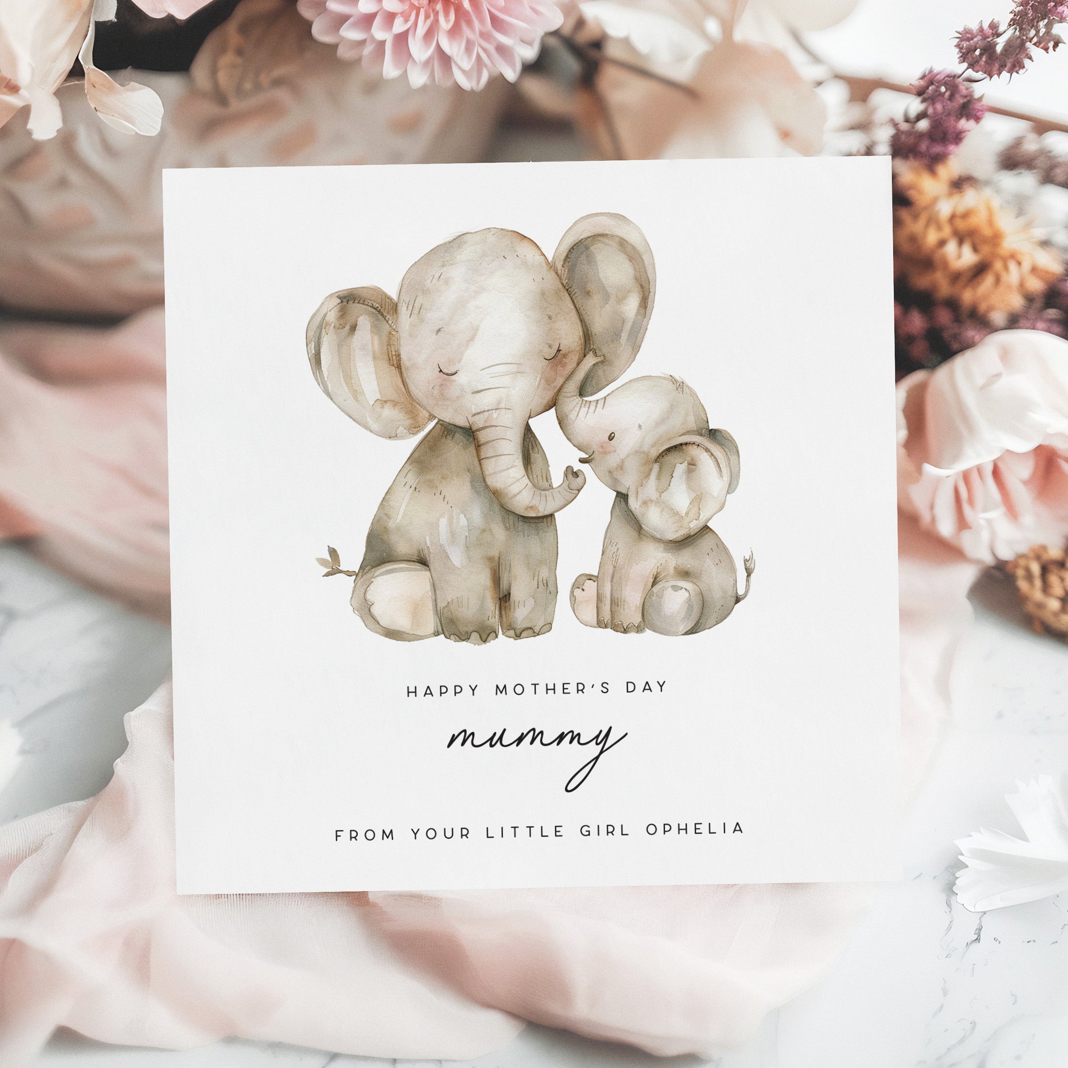 Greeting card with two elephants and floral background