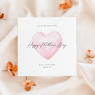 Greeting card with pink heart and 'Happy Mother's Day' text on a soft beige background with flowers.