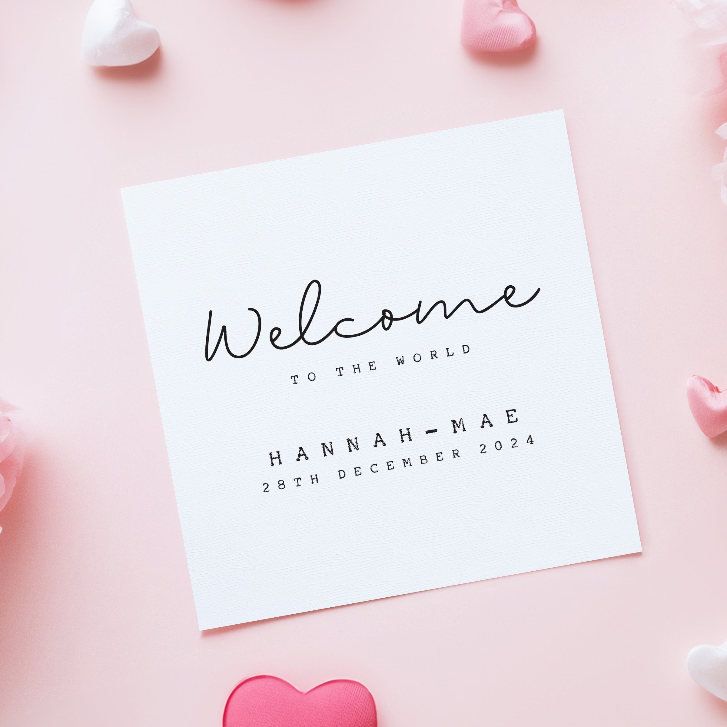 White card with 'Welcome to the World' text on a pink background