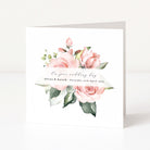 Wedding invitation card with pink roses and greenery on a white background