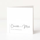 White card with black text 'Charlotte + Mark On your Wedding Day' on a white background