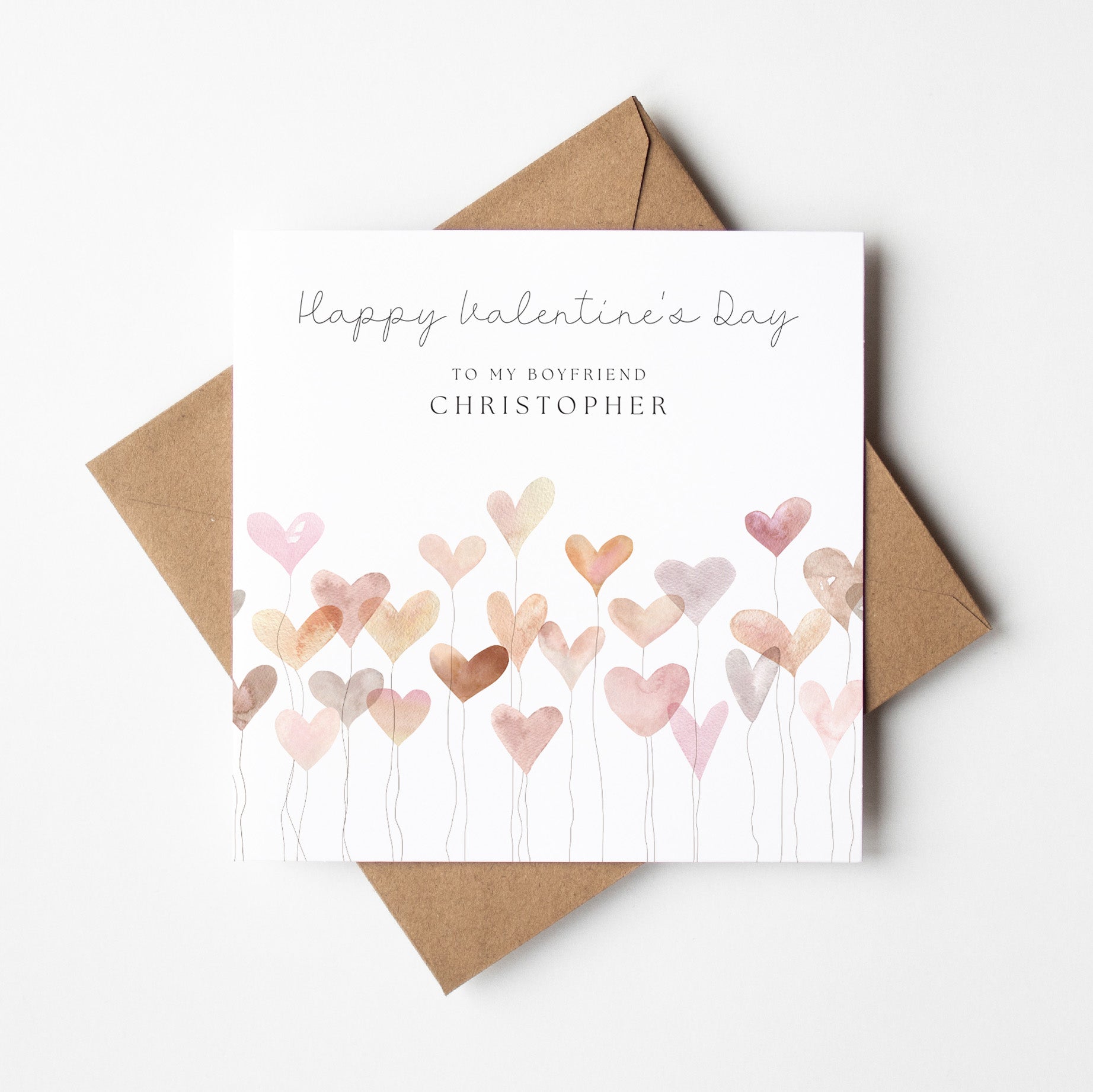 Valentine's Day card with heart designs and a brown envelope on a white background
