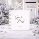 Personalized guestbook with 'Sarah & Niall' on a decorative background with flowers