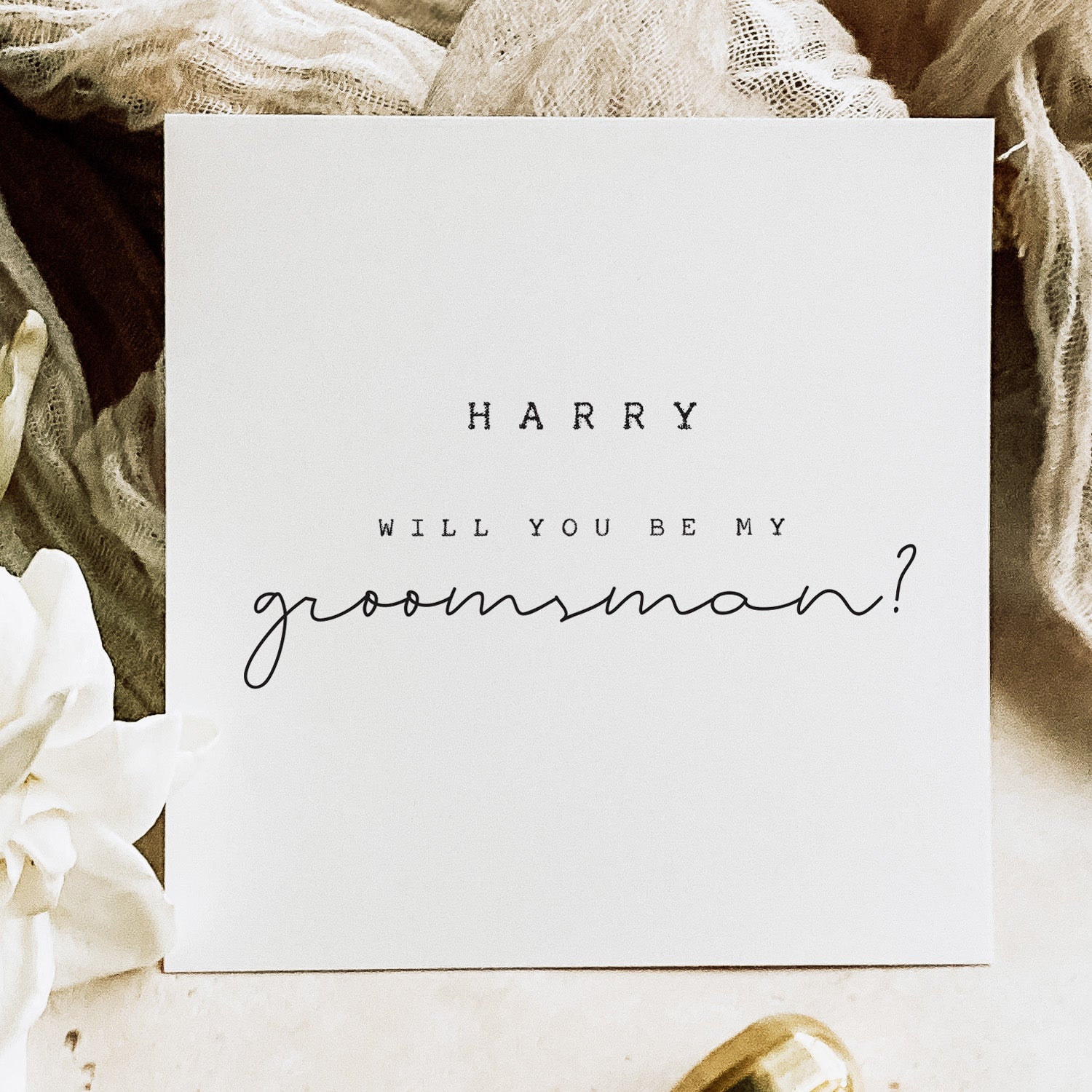 Card asking 'Harry, will you be my groomsman?' on a decorative background with flowers and ribbons.