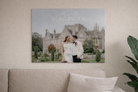 Acrylic print of a couple in front of a large house on a wall above a sofa.