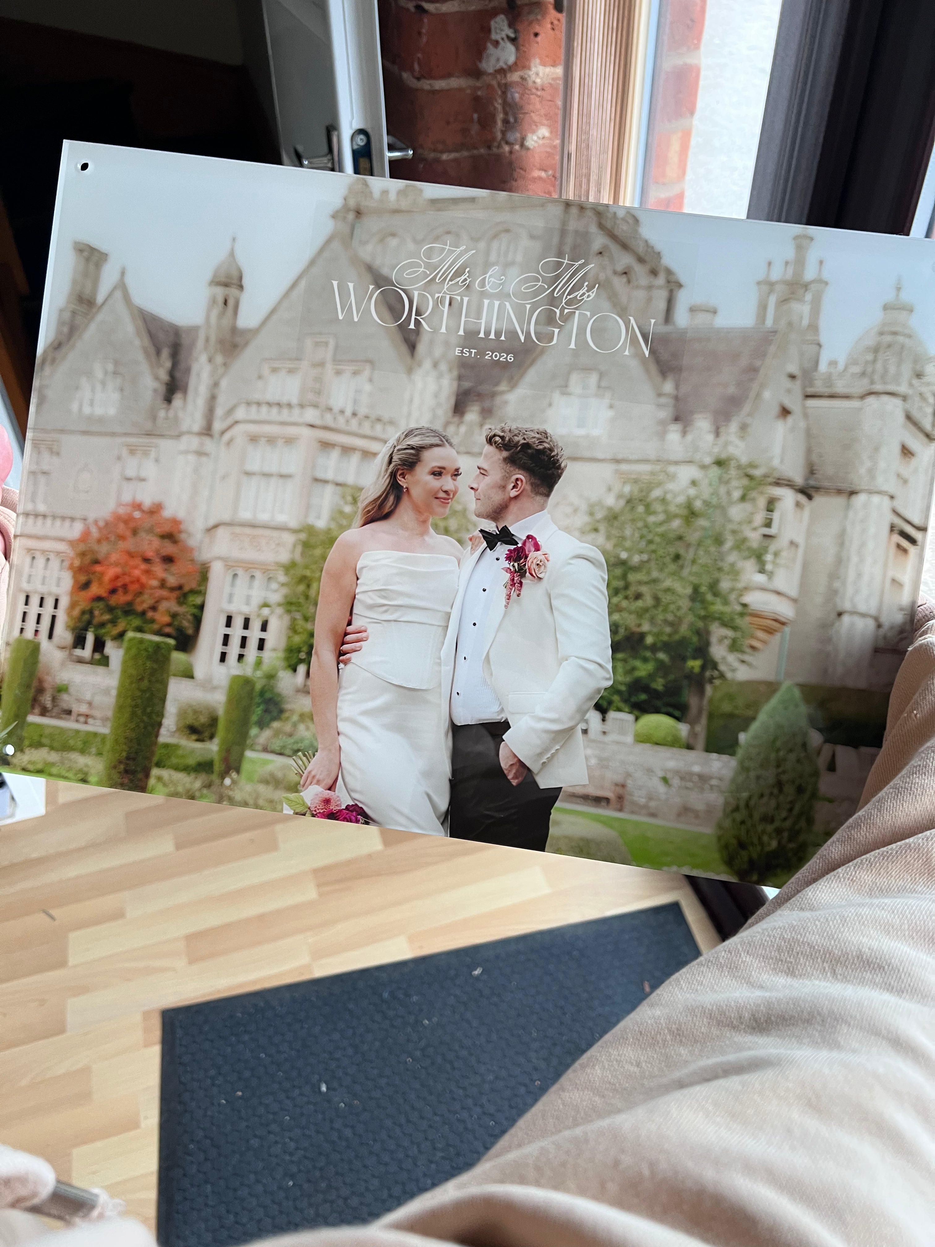 Acrylic photo with a couple in formal attire and a castle in the background.