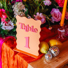 Table number '1' sign on a decorative table with flowers and ornaments.