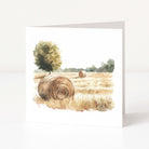 Art print of a field with hay bales and trees on a white background