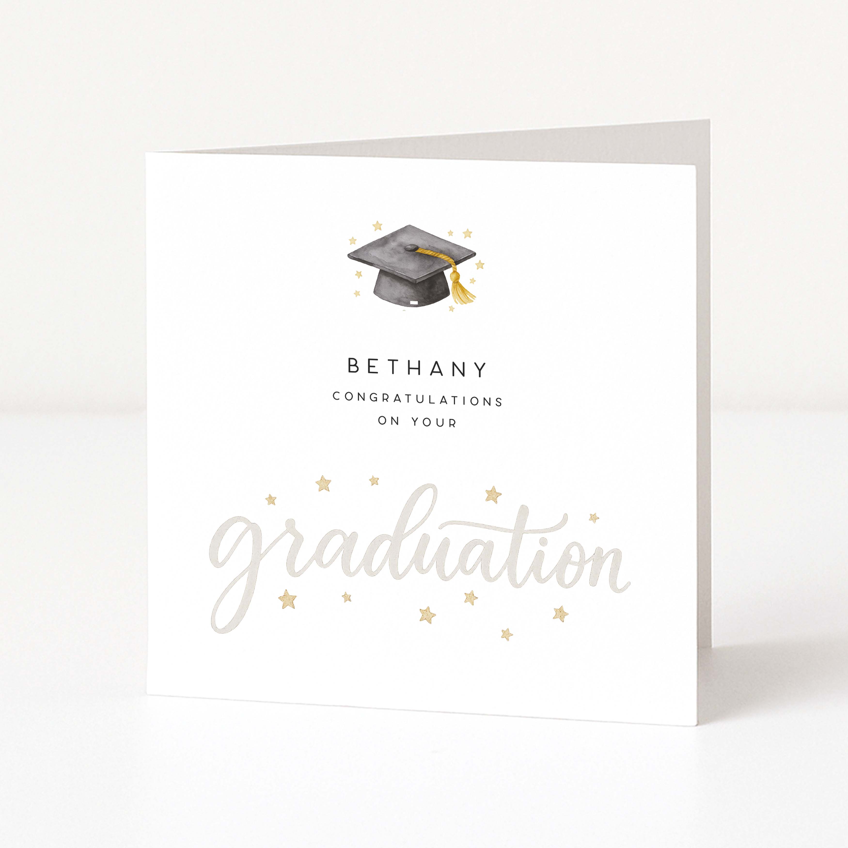 greetings card with "graduation" text on the front on a white background. 