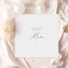 Card with 'Never too old to need my Mum' text on a soft pink fabric background with flowers.