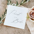 Card with 'Parents of the Bride' text on a textured surface with flowers