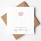 Greeting card with pink heart balloon and 'Happy Mother's Day' text on a white background with brown envelope.