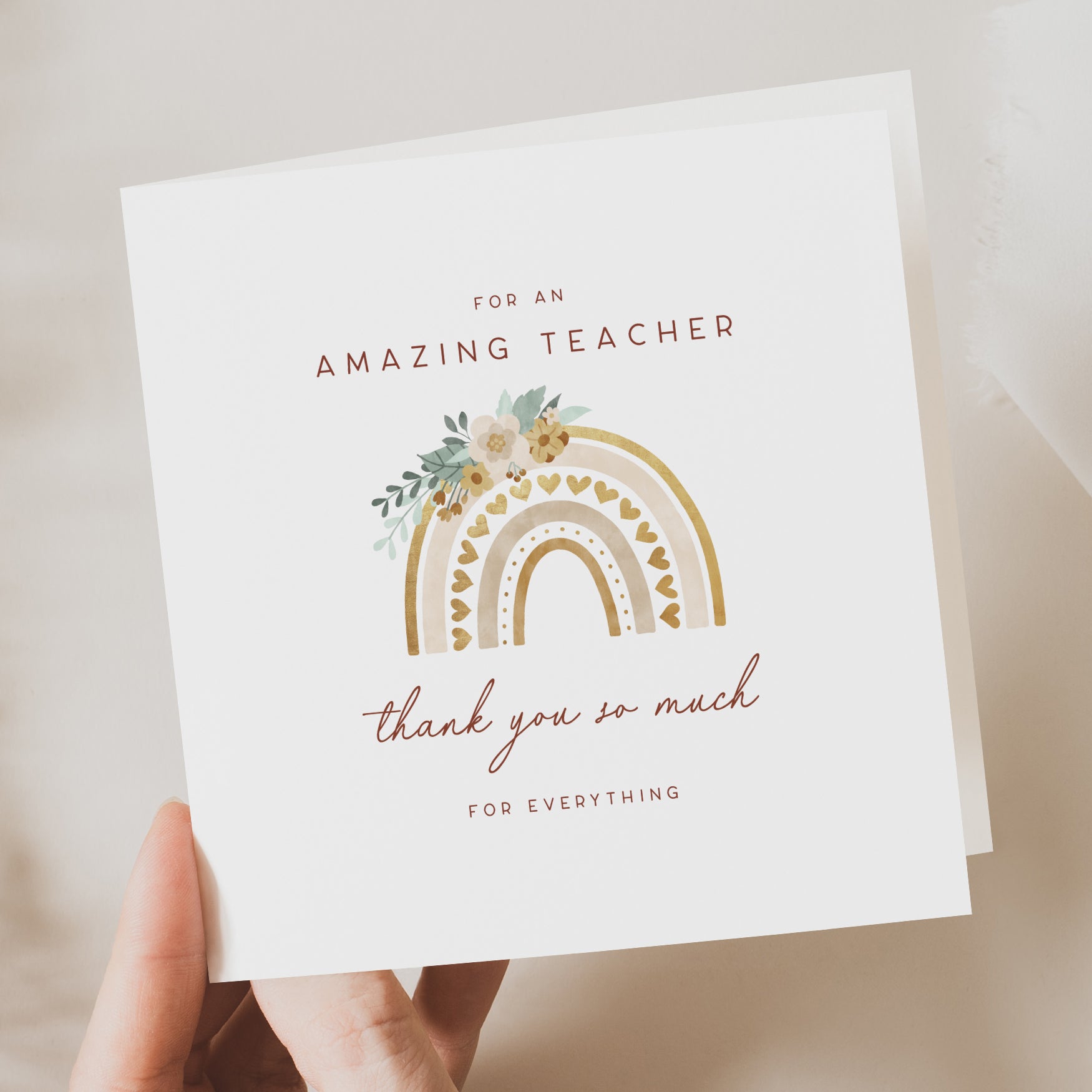 Card with rainbow design and text for an amazing teacher on a beige background