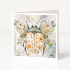 Greeting card with a beetle design featuring floral patterns on a white background