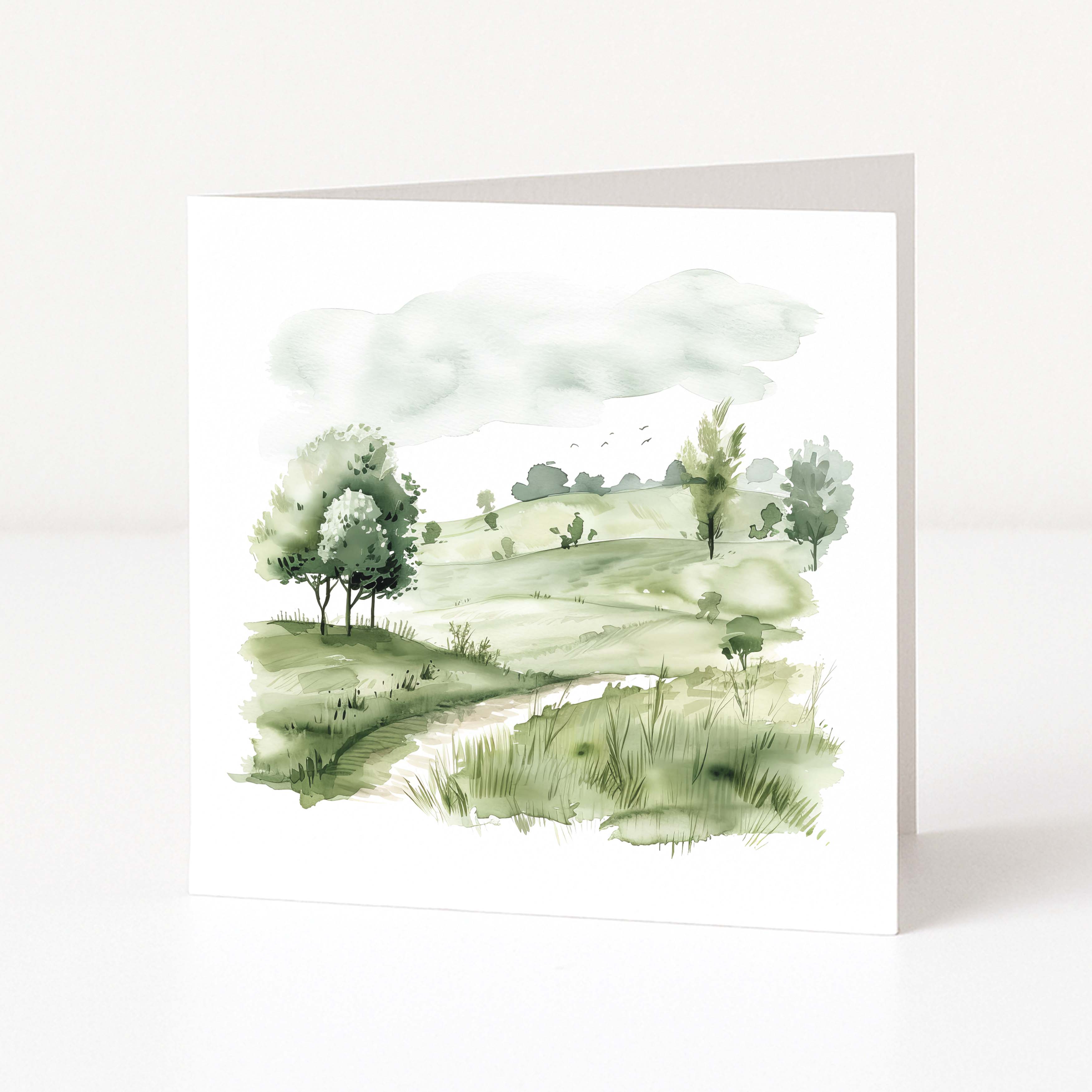 Watercolor landscape painting of a green field with trees on a white background