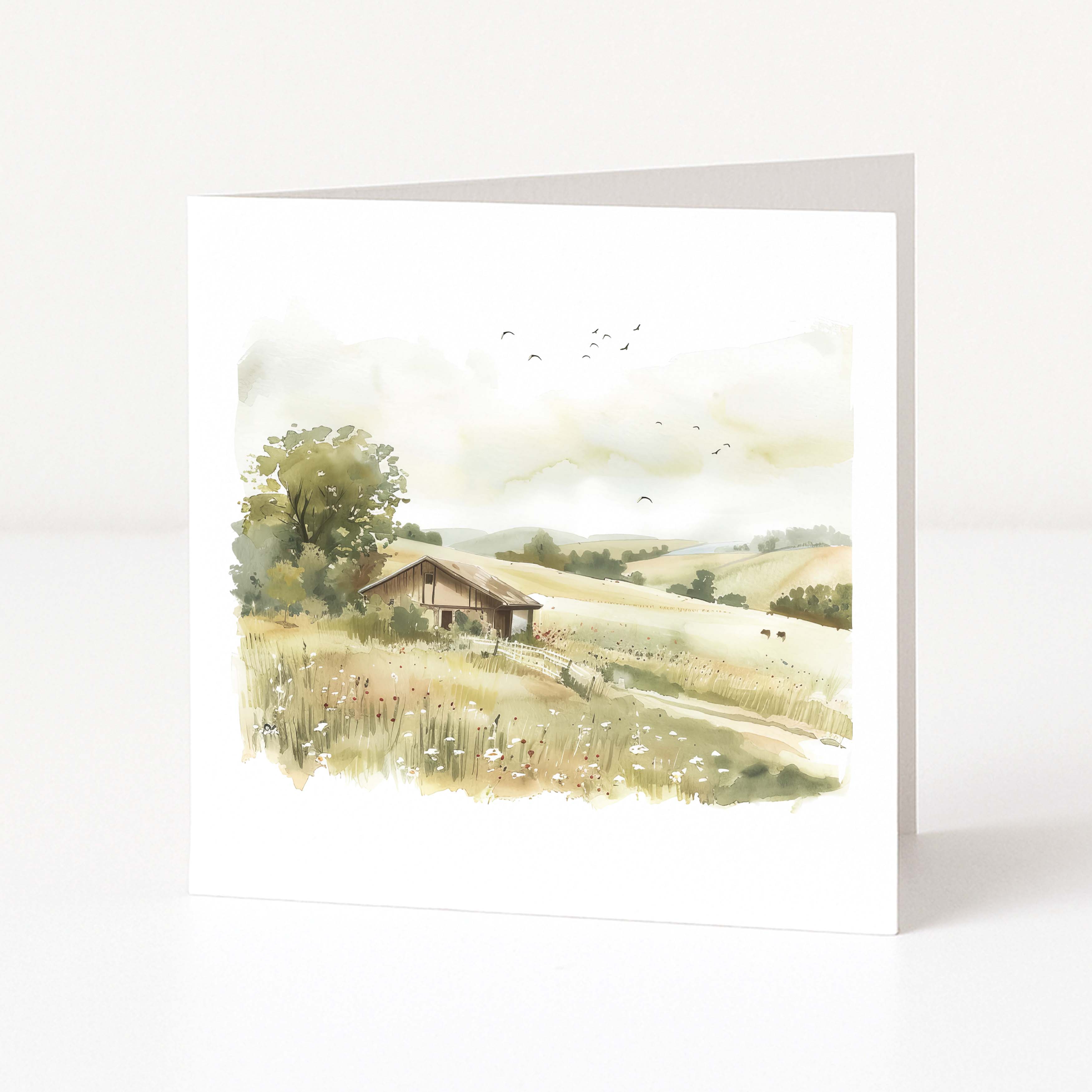 Greeting card with a scenic illustration of a hay barn in a field on a white background