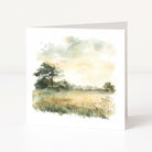 Greeting card with a watercolor landscape of trees and fields on a white background