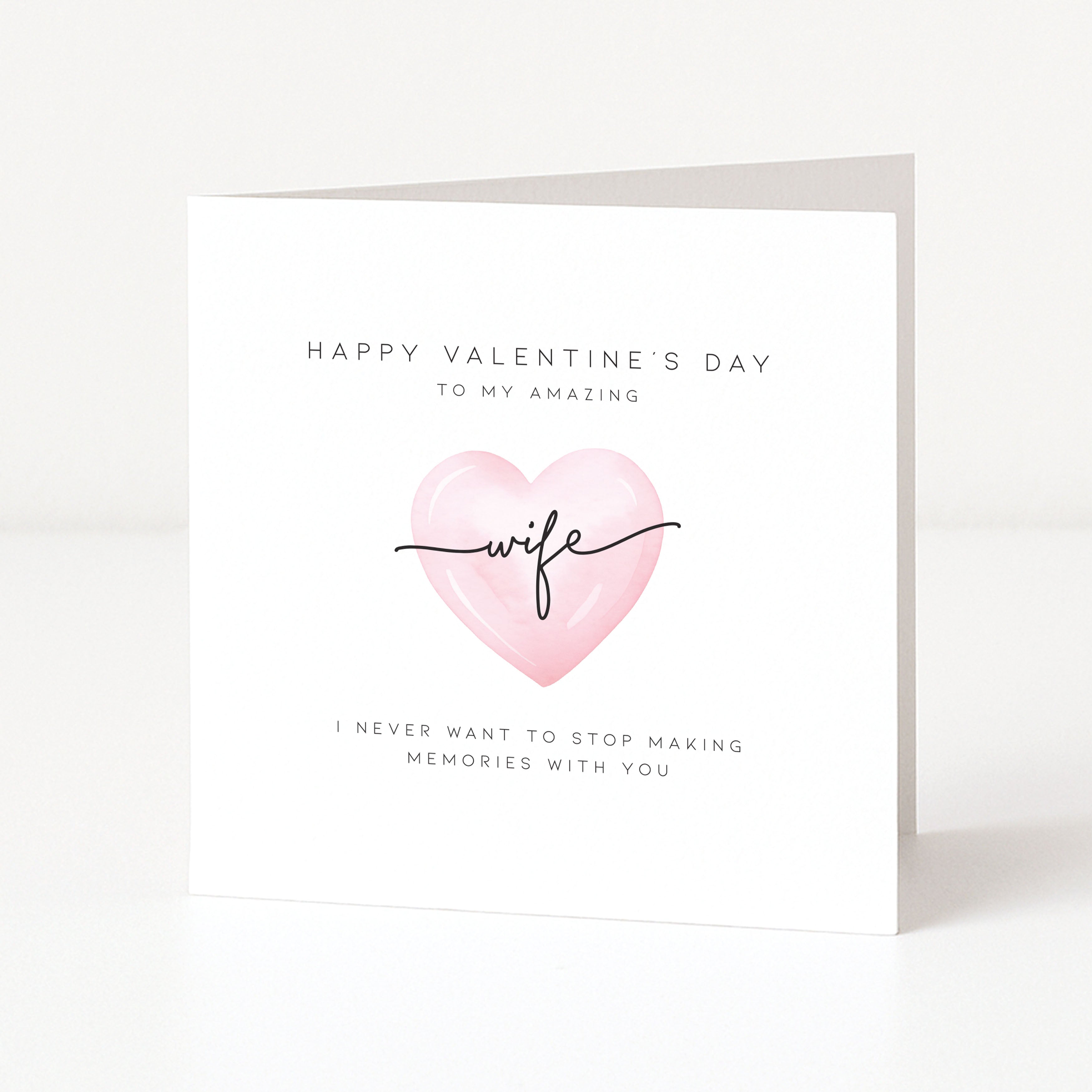 Valentine's Day card with pink heart and text on a white background
