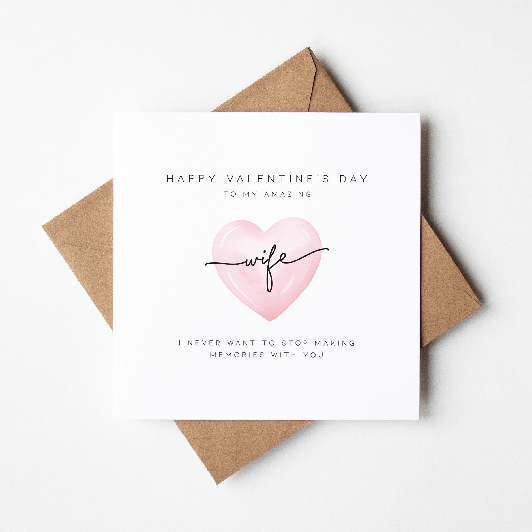 Valentine's Day card with pink heart and text on a white background