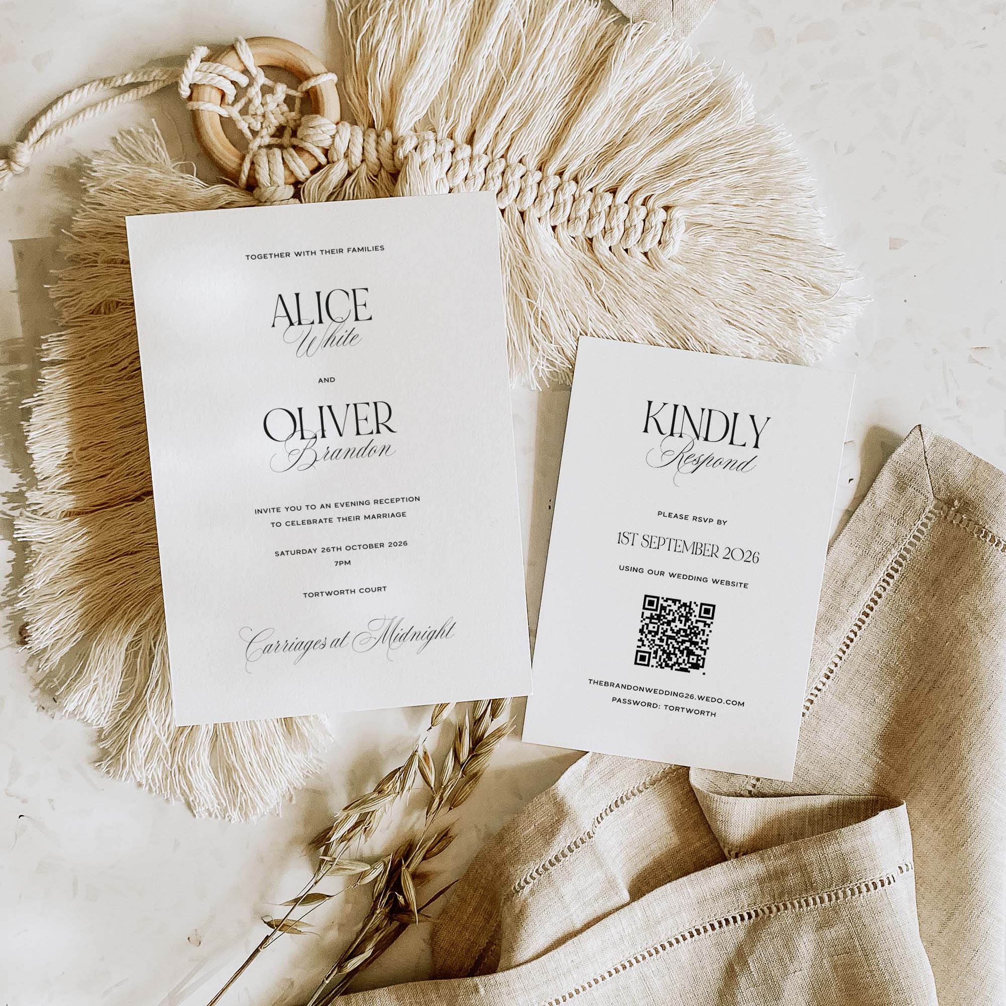 Wedding invitation and RSVP card on a textured surface with decorative elements.