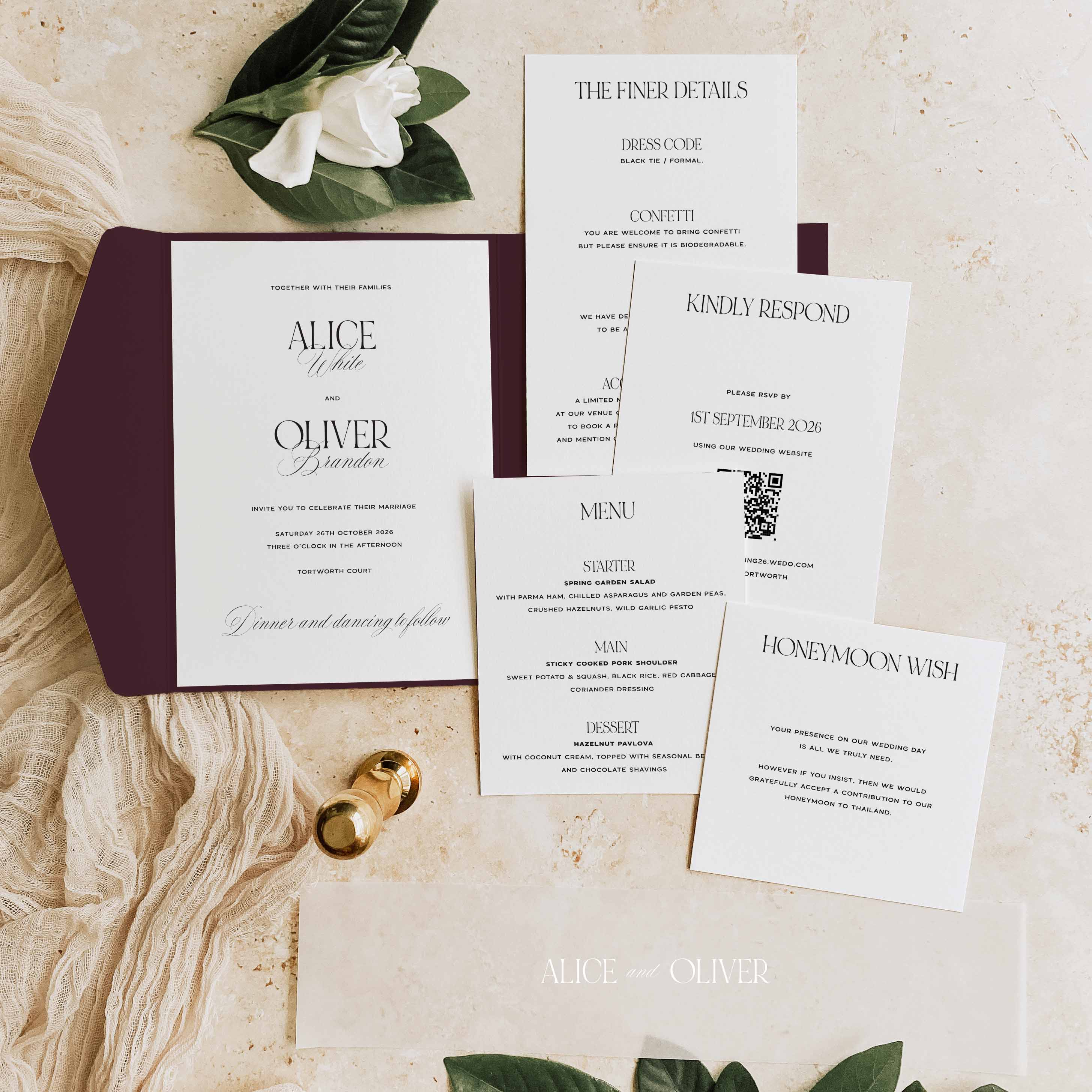 Wedding invitation set with envelope, RSVP card, and menu on a marble surface.