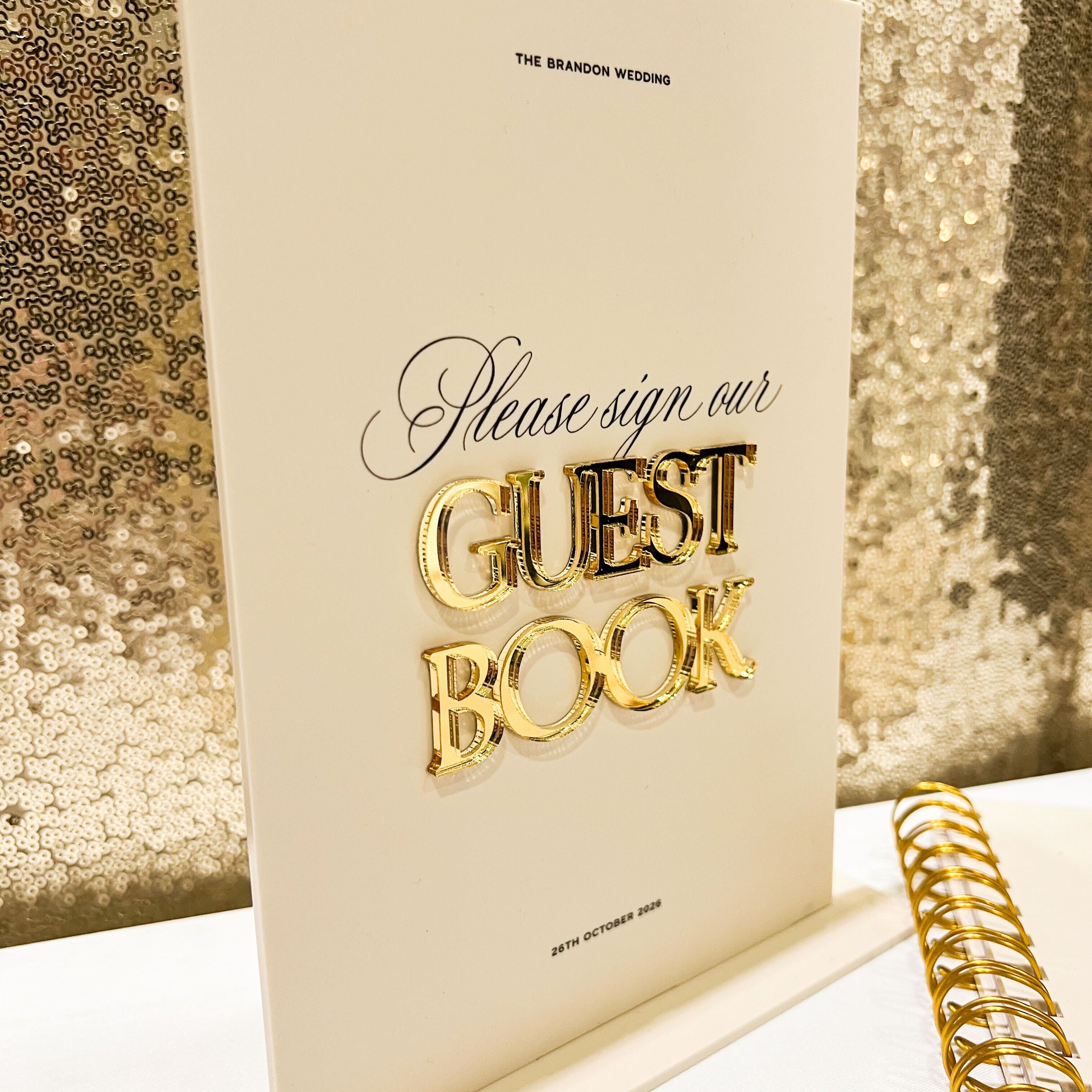 Guest book with gold text on a sequin background