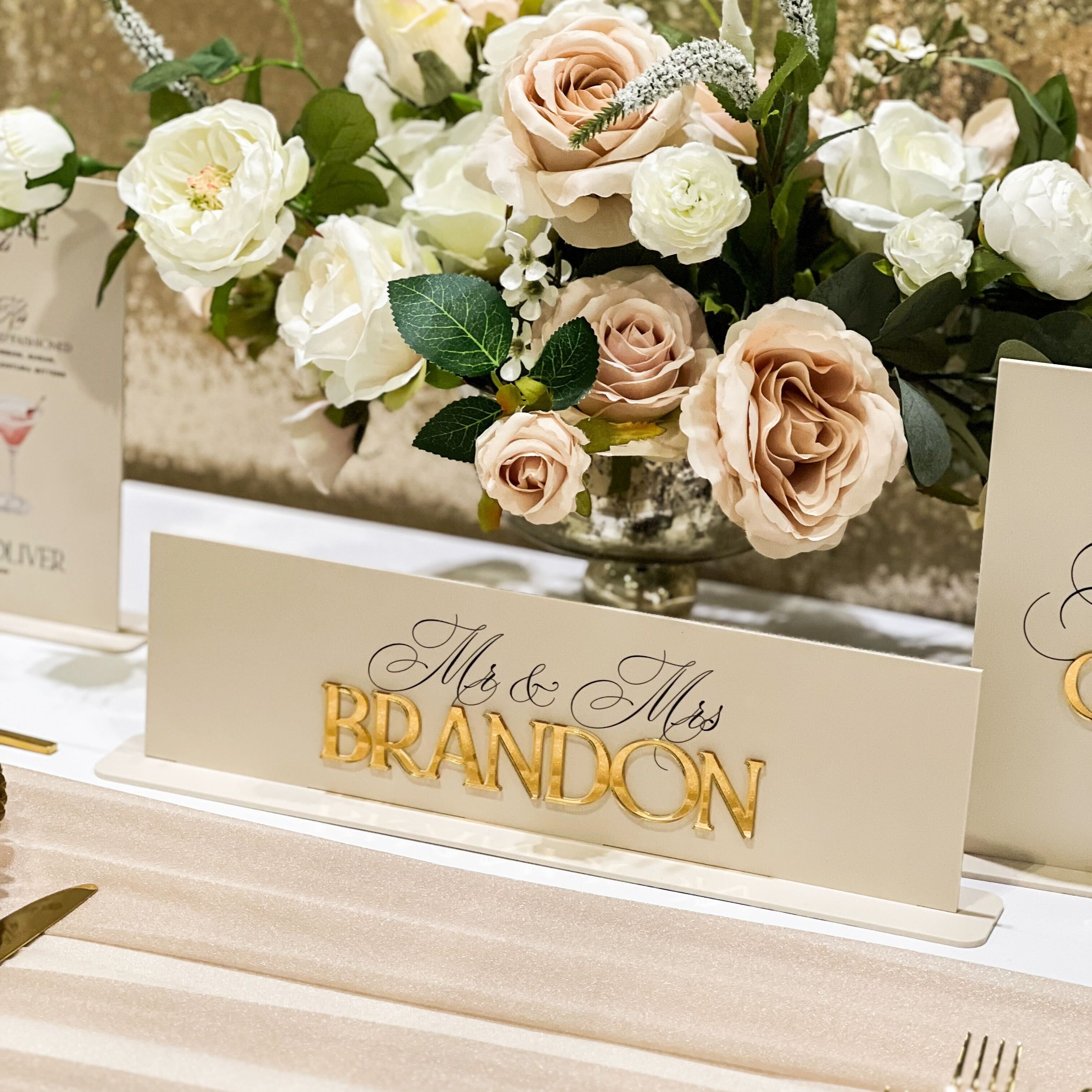Decorative table setting with flowers and a name card for 'Mr & Mrs Brandon'.