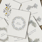 Set of Christmas cards with floral wreath designs on a white background