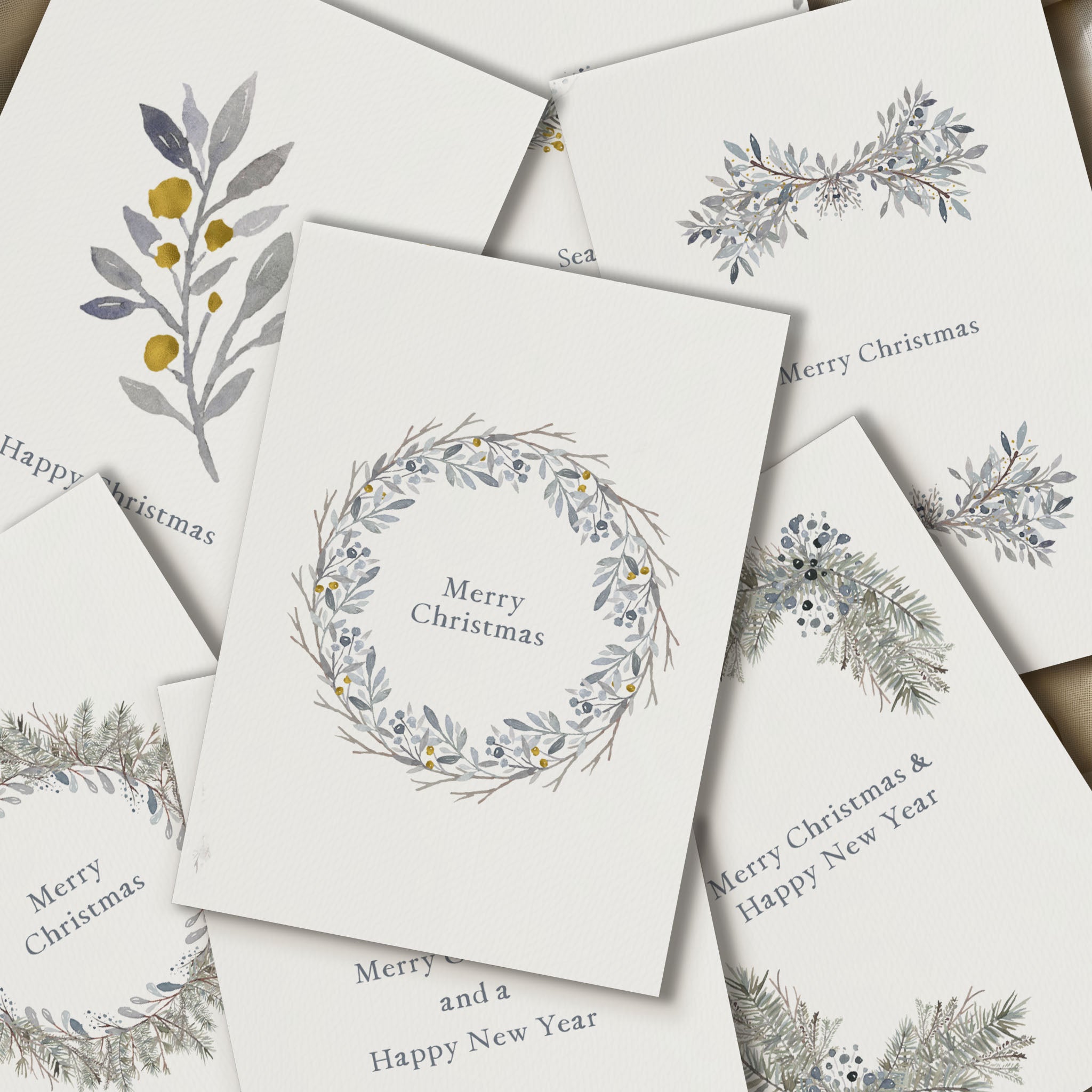 Set of Christmas cards with floral wreath designs on a white background