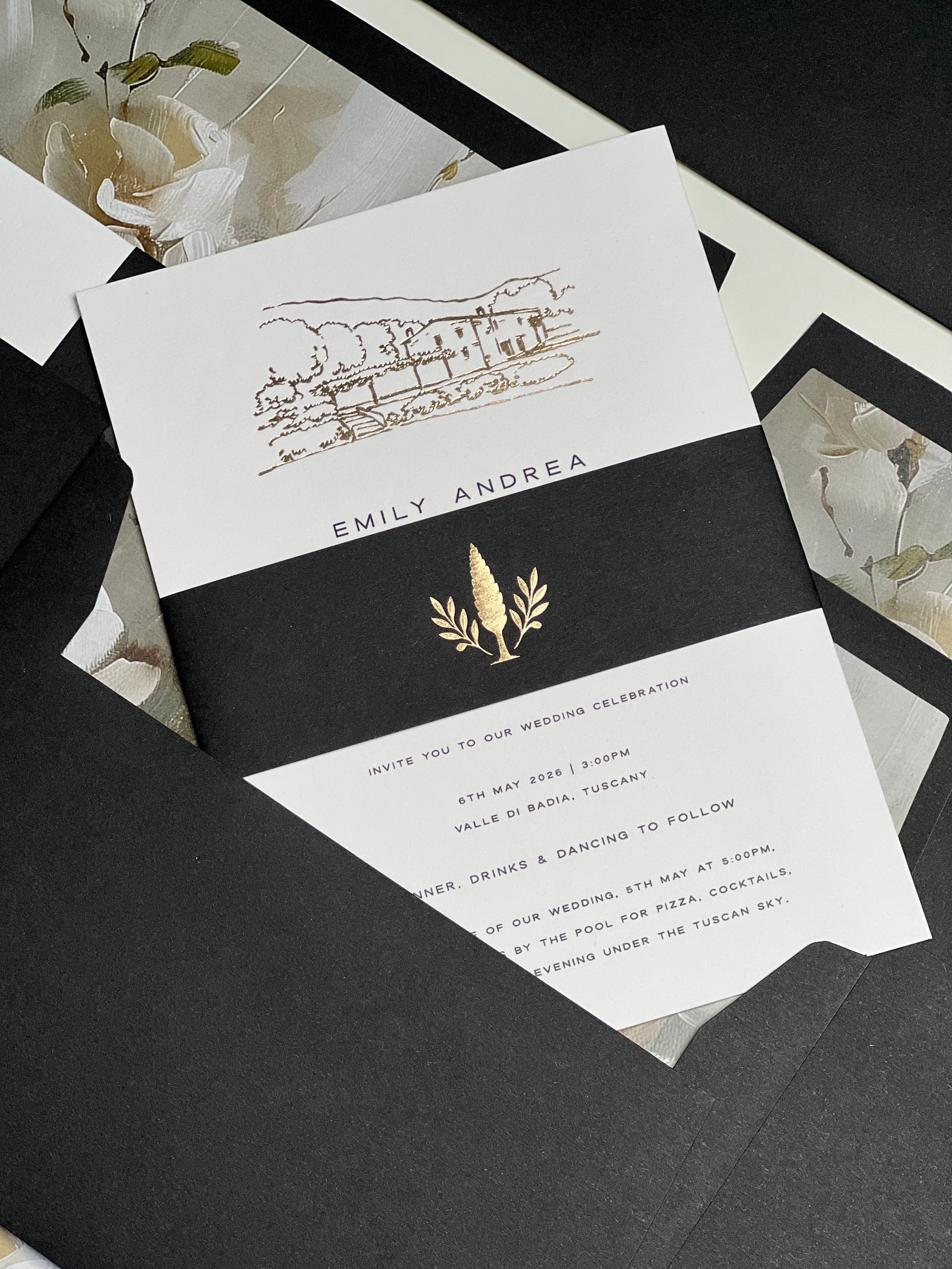 Wedding invitation card with gold and black design on a dark surface