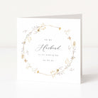 Greeting card with floral wreath and text 'To my Husband on our wedding day' on a white background