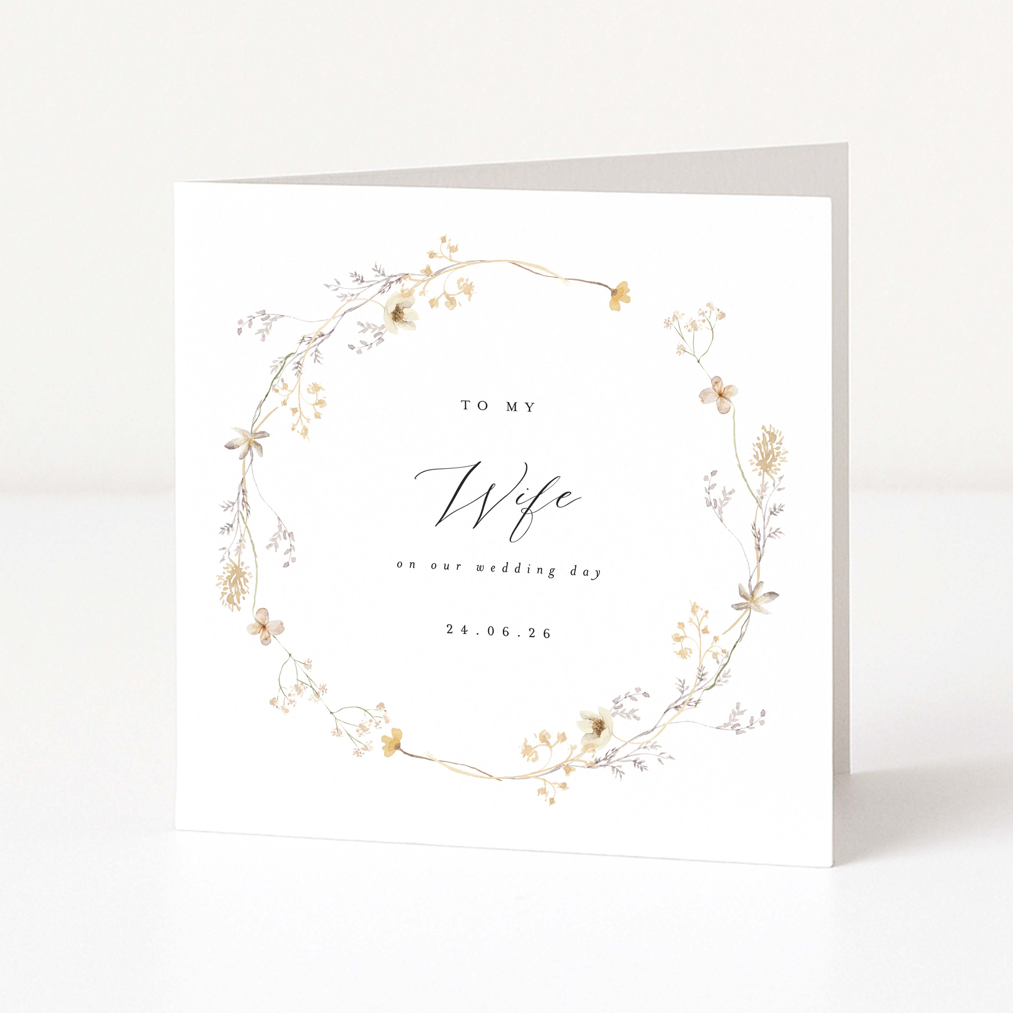 Greeting card with floral design and text 'To my Wife on our wedding day' on a white background