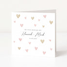 Wedding card with heart designs and personalized text on a white background