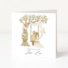 Wedding card with a couple on a swing under a tree, surrounded by flowers and balloons.