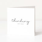 Greeting card with 'thinking of you' text on a white background