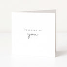 Greeting card with 'Thinking of you' text on a white background
